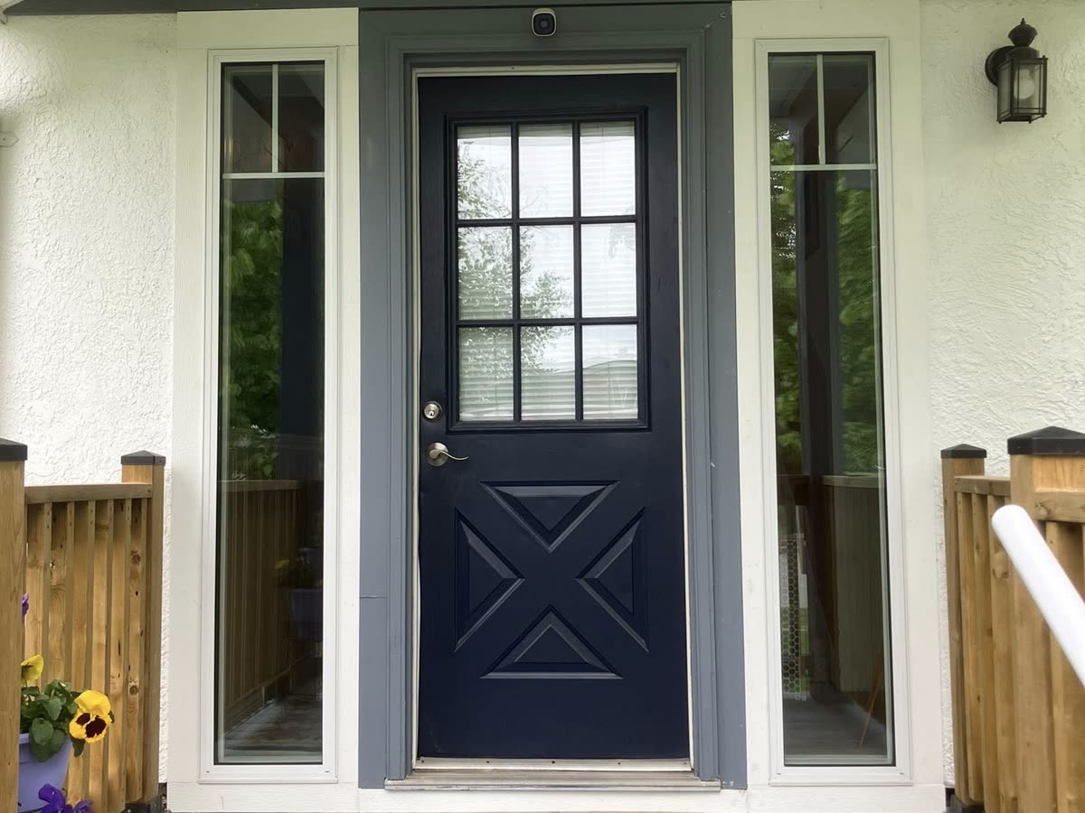 New navy entry door with crossbuck panels and glass sidelites installed by Lipstick Property Solutions