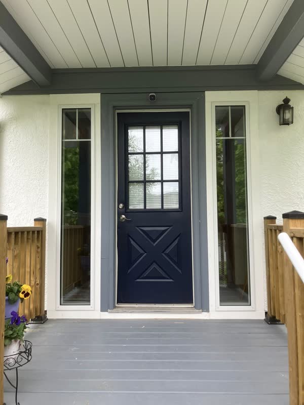Navy entry door with crossbuck panels and glass sidelites