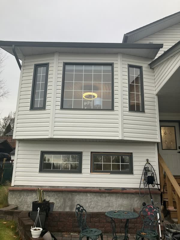 New grid bay window and basement windows on a white two-storey