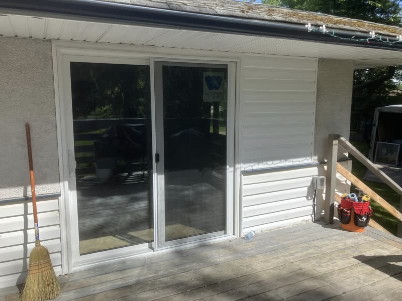 New white patio slider door on a back deck