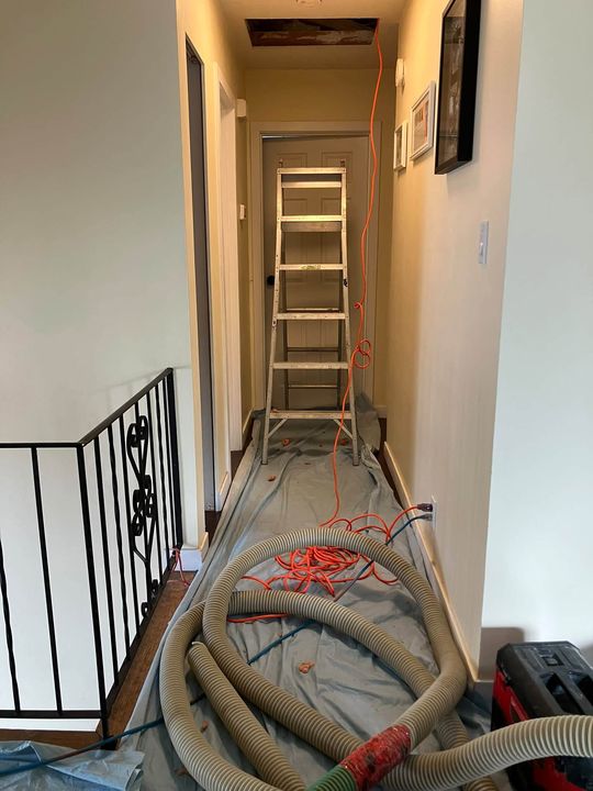 Hose run up a protected hallway to the attic hatch
