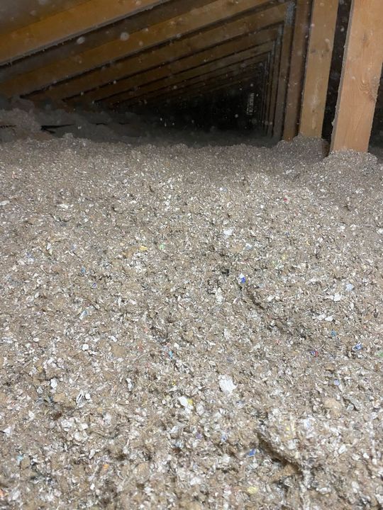 Finished blanket of blown-in cellulose insulation