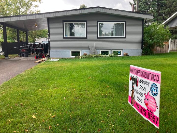 Grey bungalow with a Lipstick lawn sign before the basement window upgrade