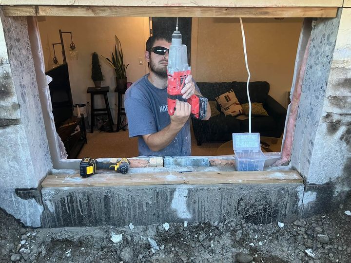 Installer inside the newly cut basement opening