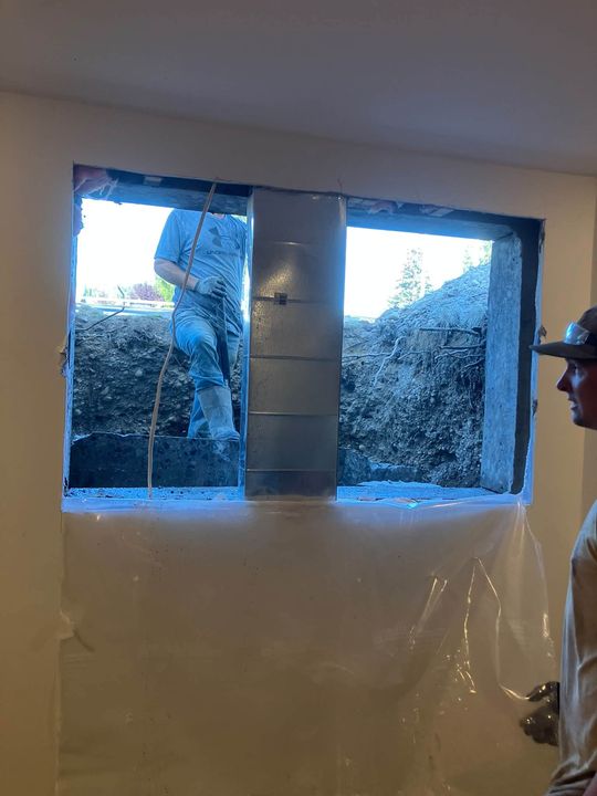 Enlarged basement openings from inside, wrapped for dust