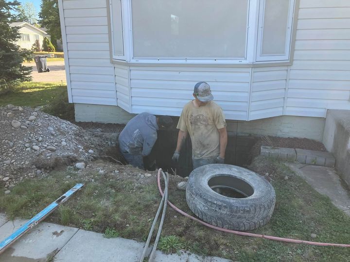 Crew digging out the window well area