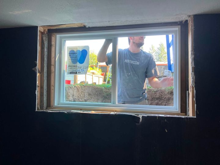 New egress window being set in place, seen from inside