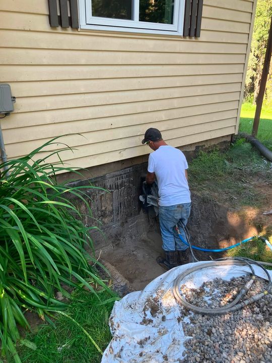 Installer working at the foundation cut