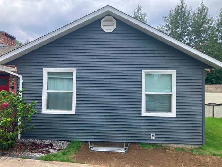 Grey-sided house with the finished egress window well