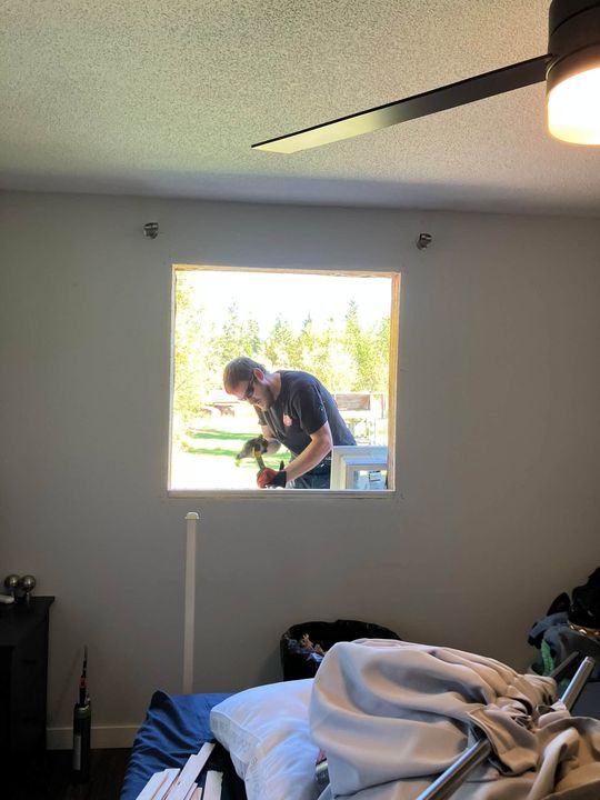 New window in a bedroom with a ceiling fan