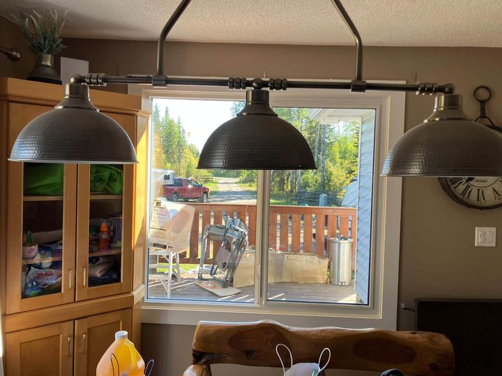 Dining area with a new window beyond the pendant lights