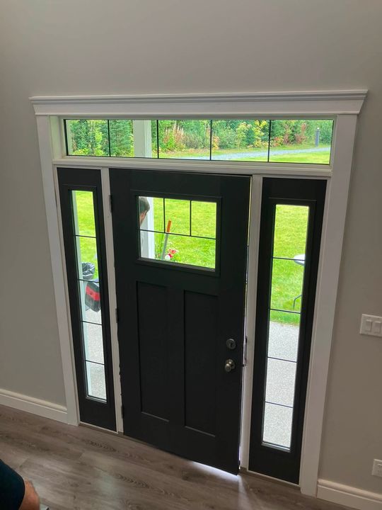 Black entry door with sidelites and transom, seen from inside