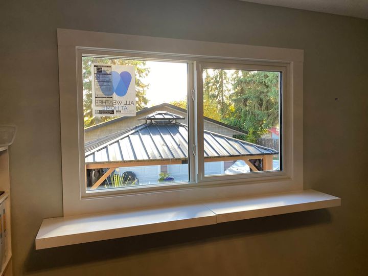 New triple-pane window above a window seat, backyard gazebo outside