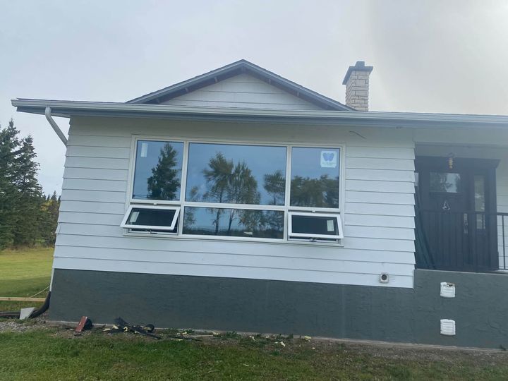 White bungalow with all six new triple-pane windows installed