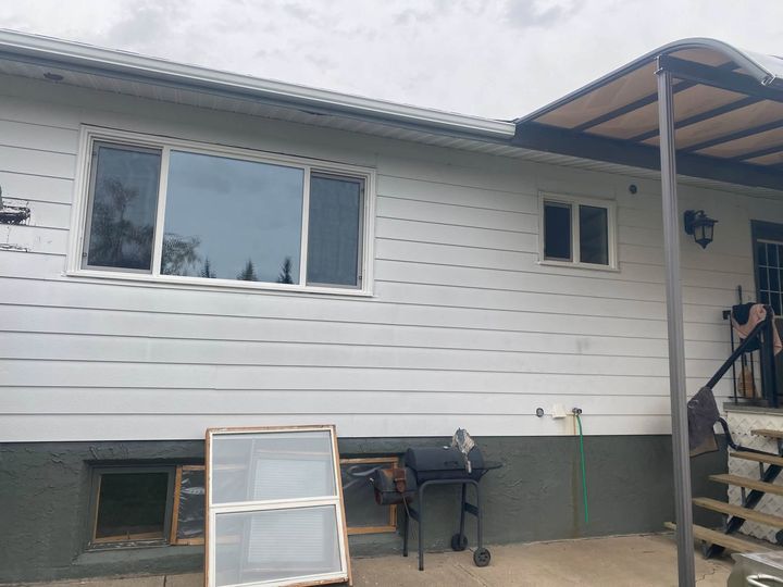 Back of the house with an old window set aside during the install