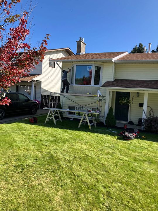 Crew installing the bay window at the front of the house