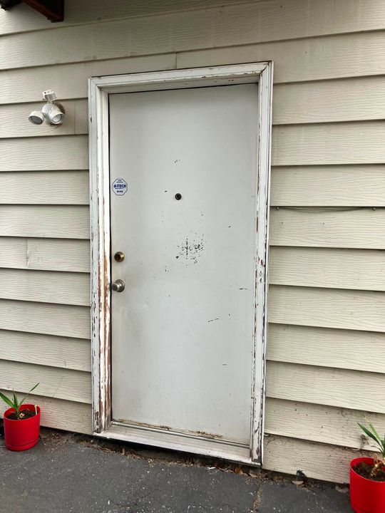 Before: Old weathered entry door before replacement