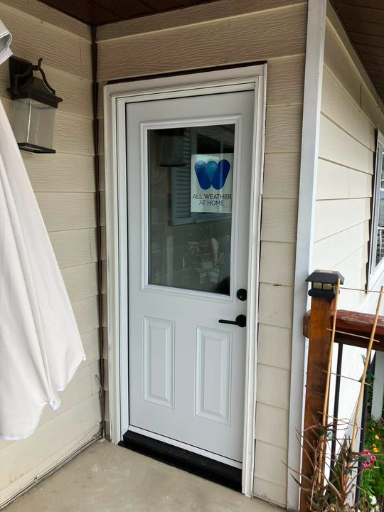 New half-lite entry door installed beside the deck