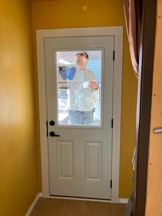 New half-lite door from inside with the yard beyond